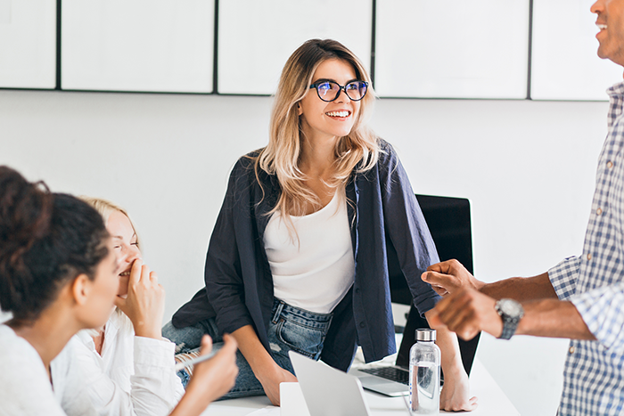 ©european female student glasses chilling table listening university friend wristwatch african young woman talking with collegues office coffee break 700px